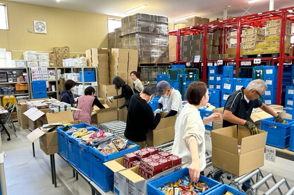 倉庫で寄付食品を仕分けするスタッフの写真